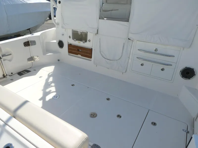 Slide: The Image of 2021 Boston Whaler 405 Conquest boat interior with white seating and storage compartments. - 5