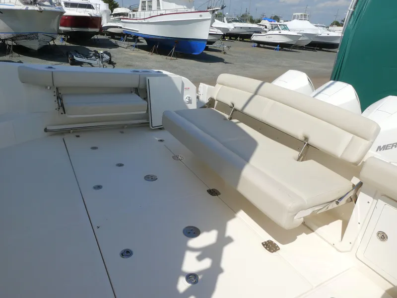 Slide: The Image of 2021 Boston Whaler 405 Conquest boat interior with beige seating and deck. - 6