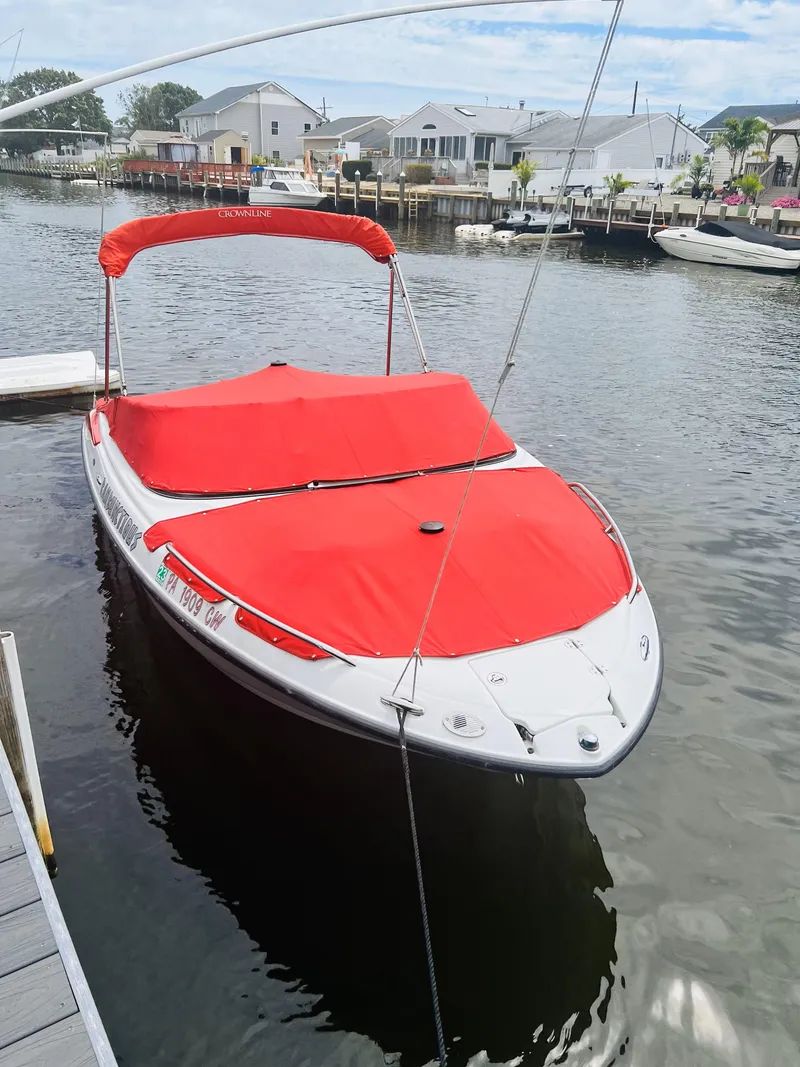 Slide: The Image of 2005 Crownline 206 LS boat with red cover docked in a marina. - 10