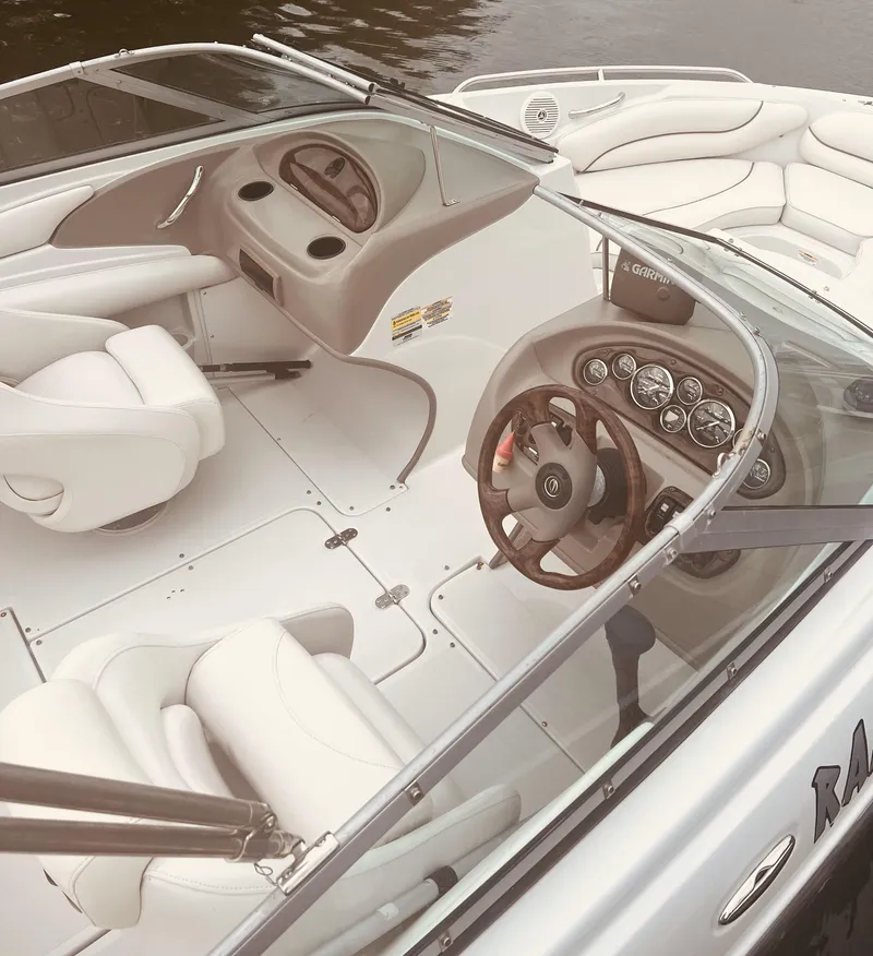 Slide: The Image of 2005 Crownline 206 LS boat interior with white seating and sleek dashboard design. - 3