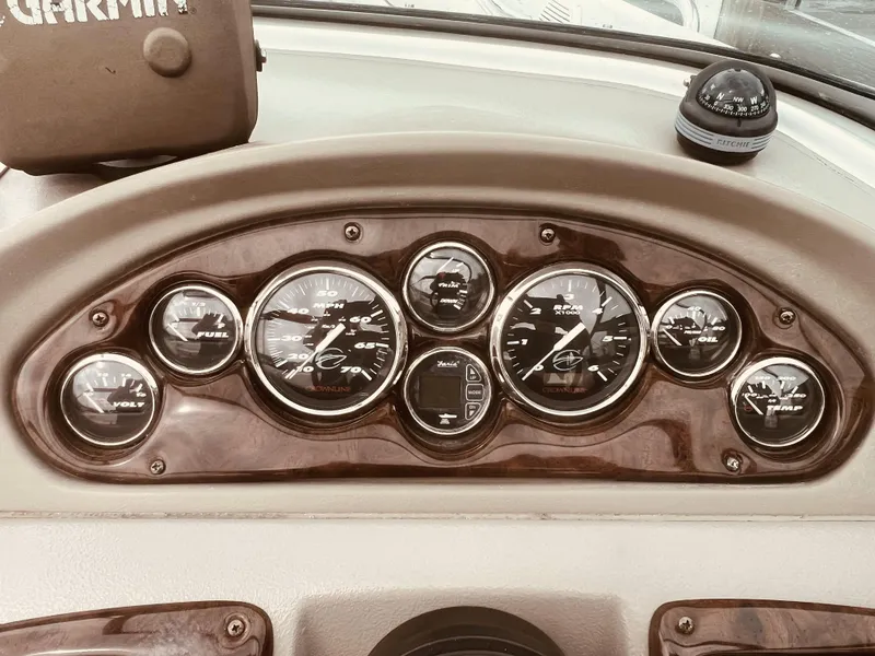 Slide: The Image of Dashboard of a 2005 Crownline 206 LS boat with gauges and compass. - 6