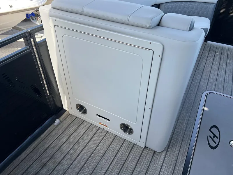 Slide: The Image of 2021 Harris FloteBote 230 Solstice boat interior with cushioned seating and storage compartment. - 15