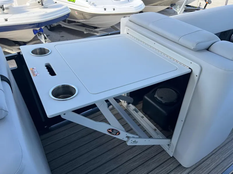 Slide: The Image of Foldable table with cup holders on a 2021 Harris FloteBote 230 Solstice boat. - 16