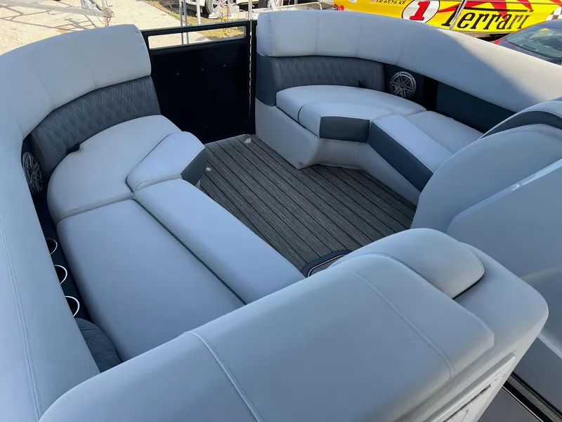 Slide: The Image of 2021 Harris FloteBote 230 Solstice pontoon boat interior with gray seating and wood flooring. - 29