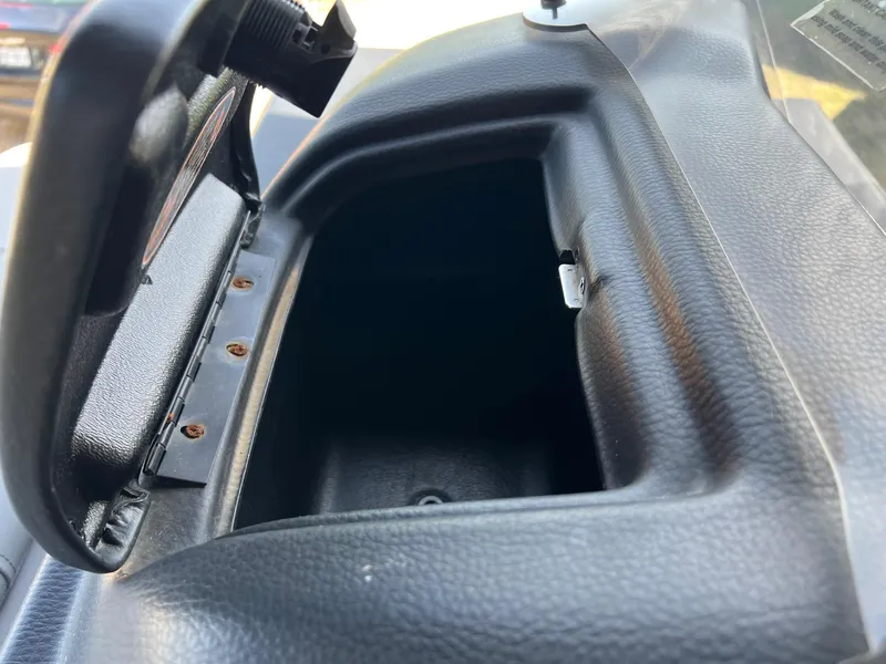 Slide: The Image of Open storage compartment in a 2021 Harris FloteBote 230 Solstice boat dashboard. - 30