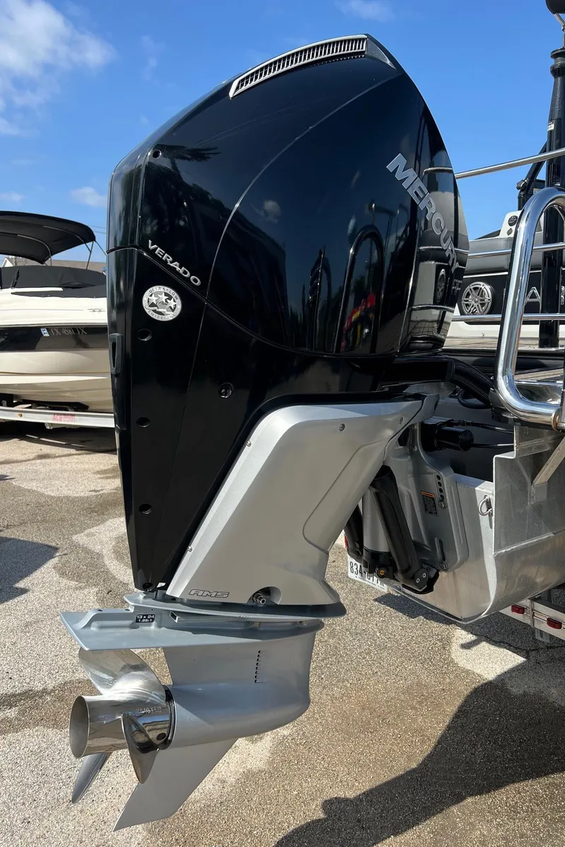 Slide: The Image of 2021 Harris FloteBote 230 Solstice with Mercury Verado outboard motor, docked under clear blue sky. - 35