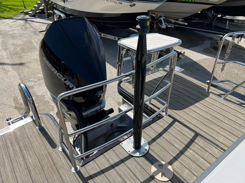 Slide: The Image of 2021 Harris FloteBote 230 Solstice boat with Mercury outboard motor, docked on wooden deck. - 4