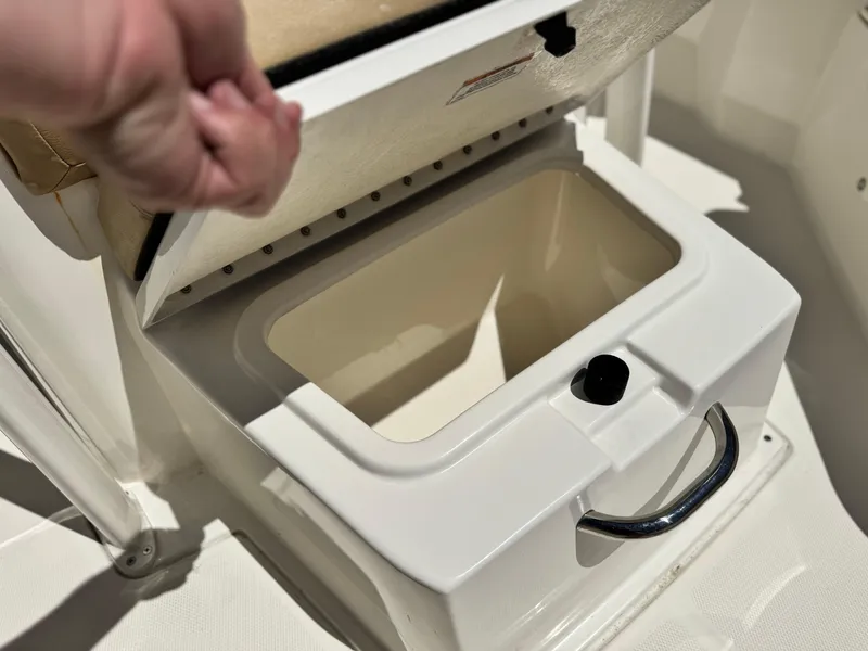 Slide: The Image of 2023 Bayliner Trophy T20CC boat storage compartment with open lid and handle. - 10