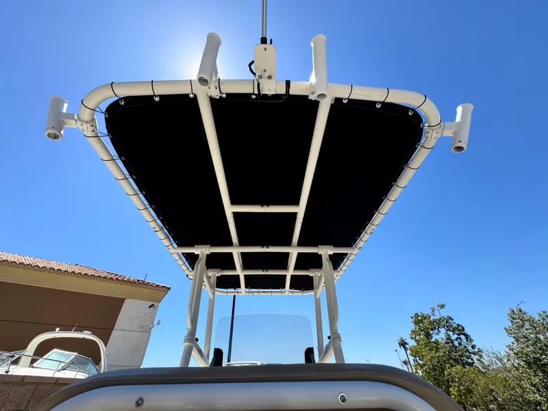 Slide: The Image of 2023 Bayliner Trophy T20CC boat with T-top under clear blue sky. - 12