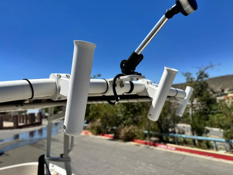 Slide: The Image of 2023 Bayliner Trophy T20CC boat rod holders and light fixture. - 13