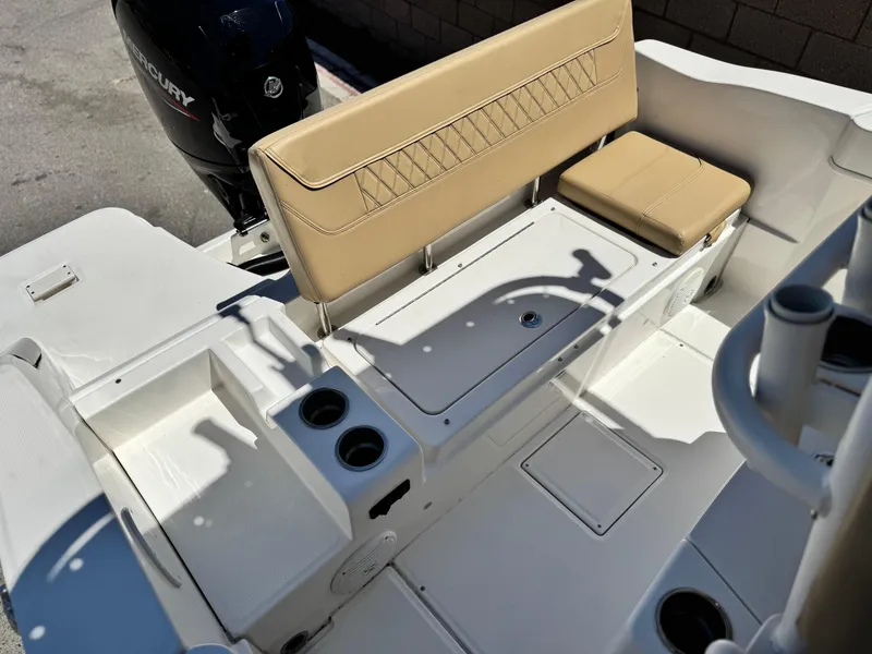 Slide: The Image of 2023 Bayliner Trophy T20CC boat interior with tan seating and cup holders. - 15
