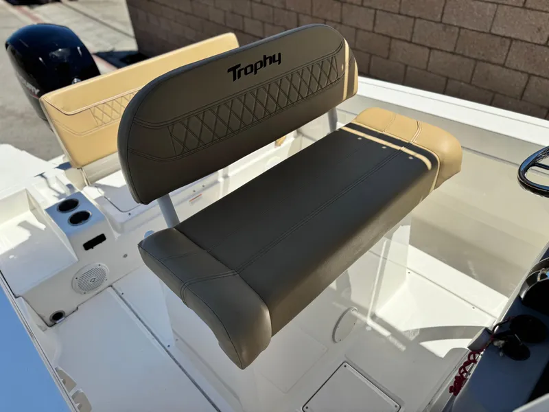 Slide: The Image of 2023 Bayliner Trophy T20CC boat seating with beige upholstery and "Trophy" branding. - 17