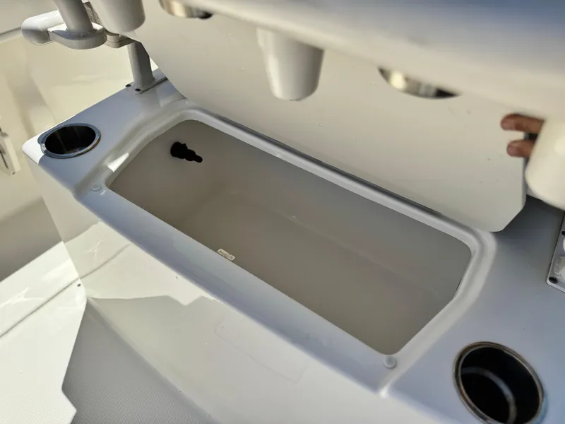 Slide: The Image of 2023 Bayliner Trophy T20CC boat storage compartment with cup holders. - 18