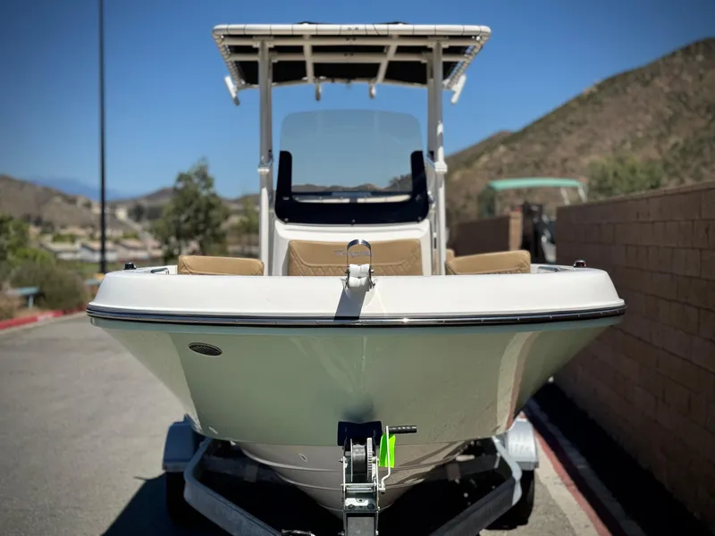 Slide: The Image of 2023 Bayliner Trophy T20CC boat on trailer, parked outdoors. - 2