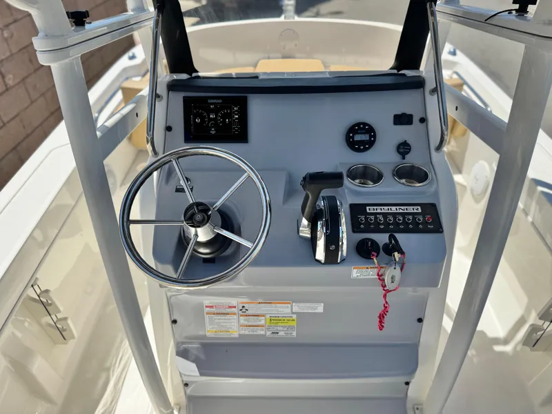 Slide: The Image of 2023 Bayliner Trophy T20CC boat console with steering wheel and controls. - 21