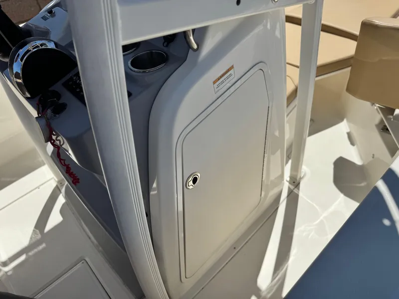 Slide: The Image of 2023 Bayliner Trophy T20CC boat console with storage compartment and steering controls. - 24