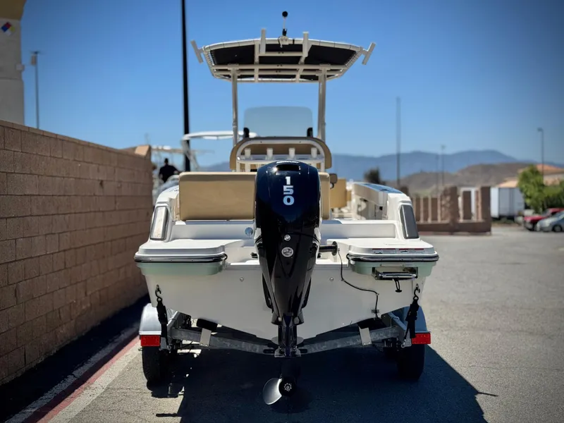 Slide: The Image of 2023 Bayliner Trophy T20CC boat with 150 HP engine, parked outdoors. - 4