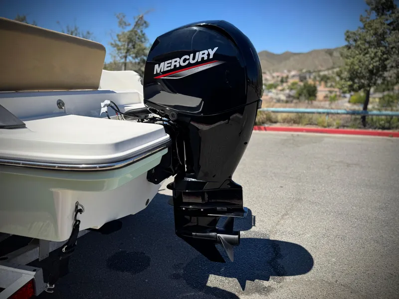 Slide: The Image of 2023 Bayliner Trophy T20CC with Mercury outboard motor in sunny outdoor setting. - 6