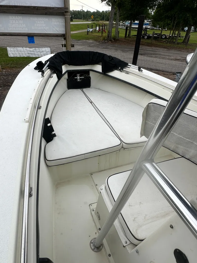 Slide: The Image of 1985 SeaCraft 23 CC boat interior with white seating and stainless steel railings. - 11