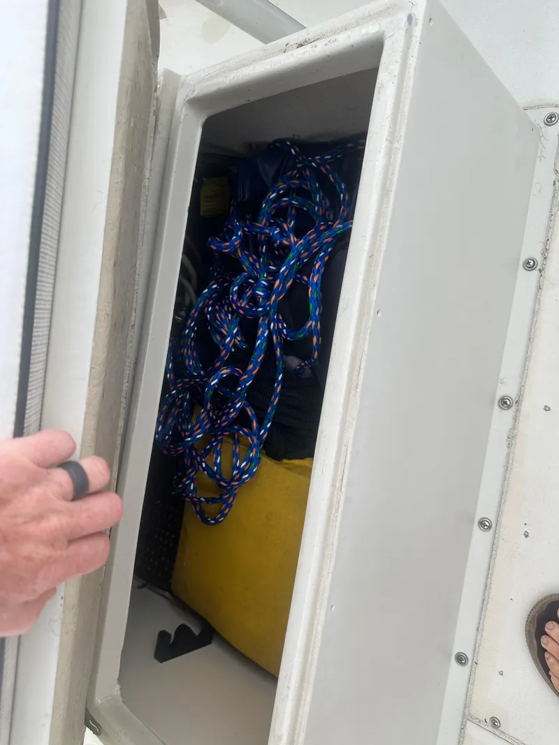 Slide: The Image of Storage compartment on a 1985 SeaCraft 23 CC boat with ropes and equipment. - 13