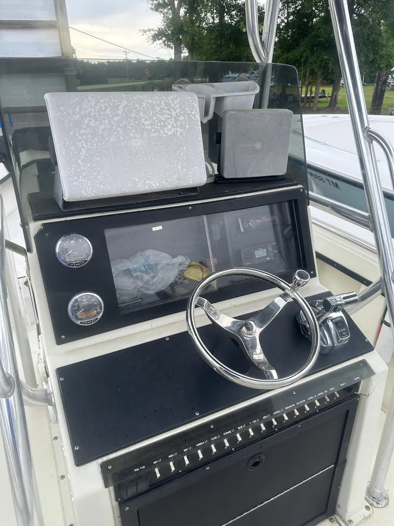 Slide: The Image of 1985 SeaCraft 23 CC boat console with steering wheel and gauges. - 16