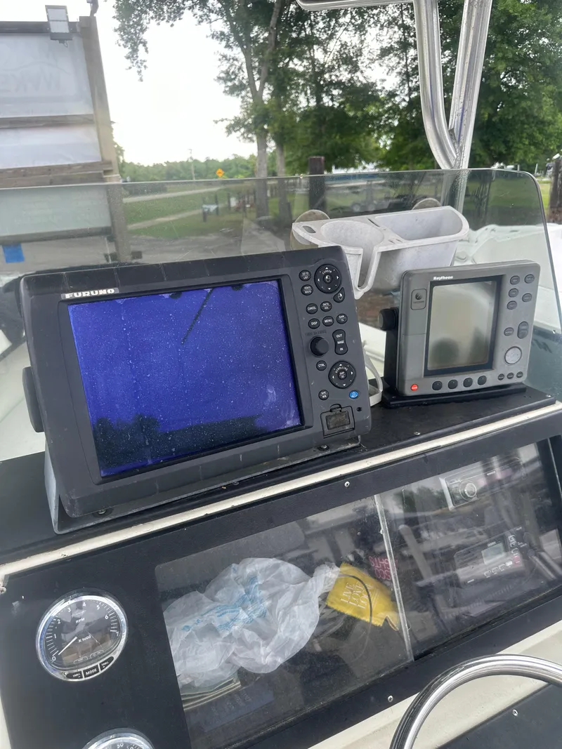Slide: The Image of 1985 SeaCraft 23 CC boat dashboard with navigation equipment and gauges. - 17