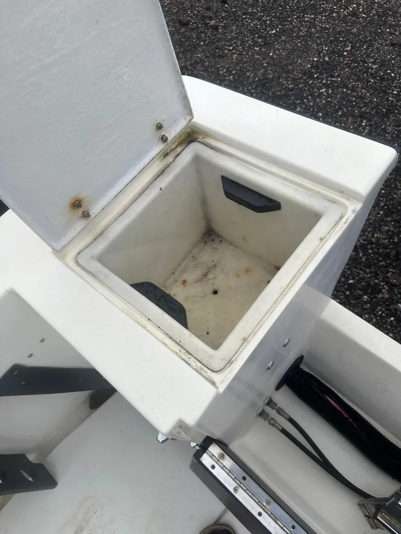 Slide: The Image of 1985 SeaCraft 23 CC boat storage compartment with open lid, showing interior details. - 20