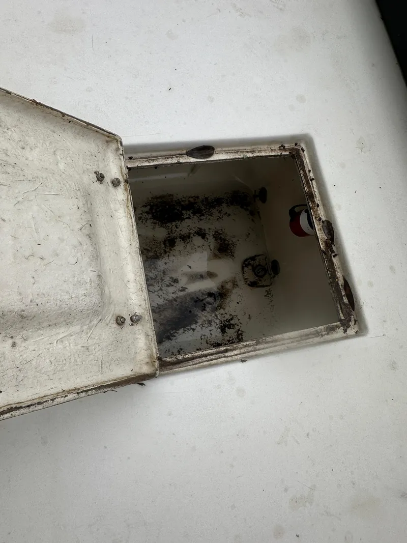 Slide: The Image of Open storage compartment on 1985 SeaCraft 23 CC boat, showing interior details. - 22