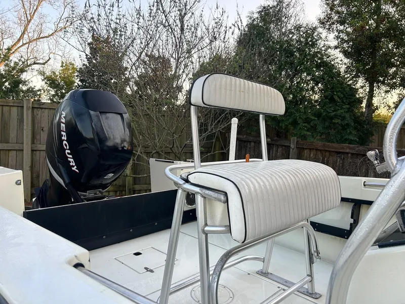 Slide: The Image of 1985 SeaCraft 23 CC boat with Mercury engine and white seating, outdoors. - 4