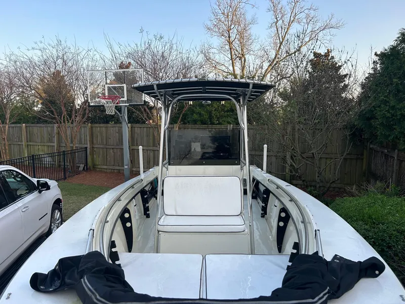 Slide: The Image of 1985 SeaCraft 23 CC boat in a backyard, near a basketball hoop and fence. - 6