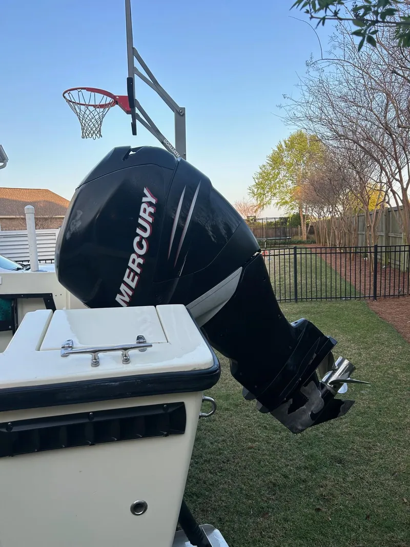 Slide: The Image of 1985 SeaCraft 23 CC boat with Mercury outboard motor in a backyard setting. - 7