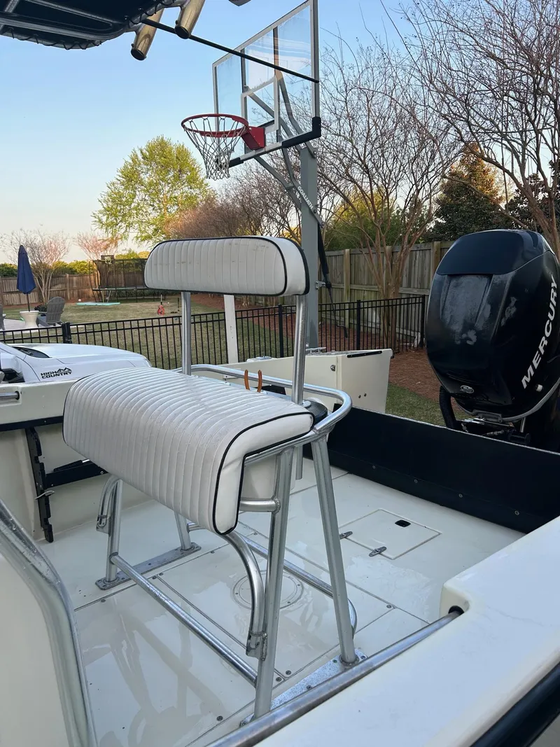 Slide: The Image of 1985 SeaCraft 23 CC boat with seating, basketball hoop, and Mercury outboard motor. - 9