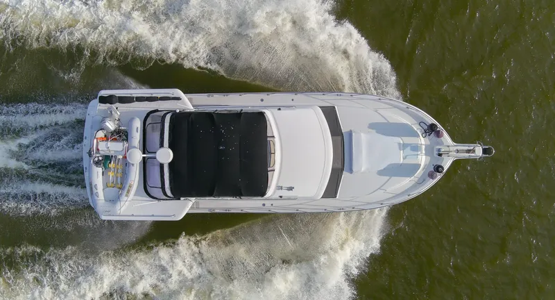 Slide: The Image of Aerial view of 1997 Carver 445 Aft Cabin Motor Yacht cruising on water. - 21