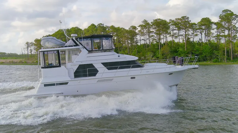Slide: The Image of 1997 Carver 445 Aft Cabin Motor Yacht cruising on a scenic waterway. - 27