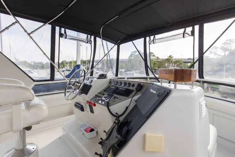 Slide: The Image of Interior helm of 1997 Carver 445 Aft Cabin Motor Yacht with steering wheel and controls. - 13
