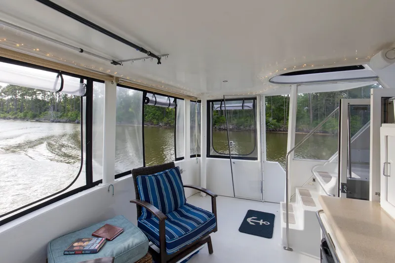 Slide: The Image of Interior of 1997 Carver 445 Aft Cabin Motor Yacht with scenic river view. - 16