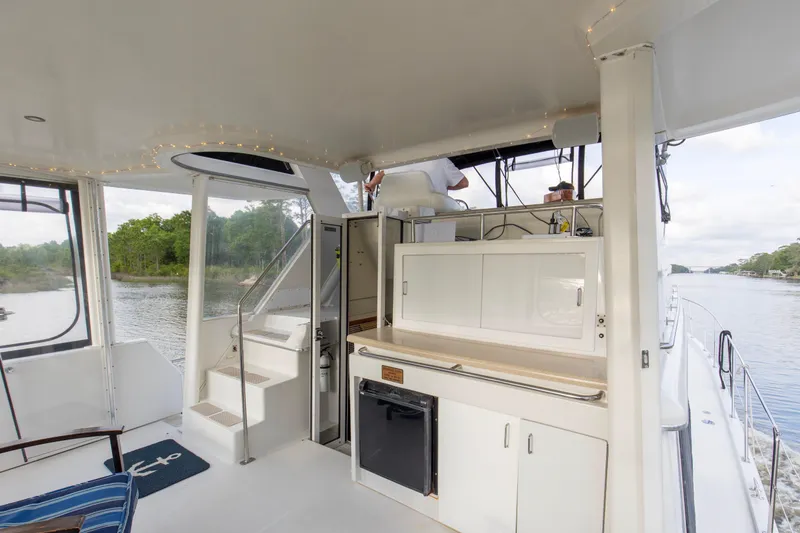 Slide: The Image of 1997 Carver 445 Aft Cabin Motor Yacht interior with kitchenette and river view. - 18