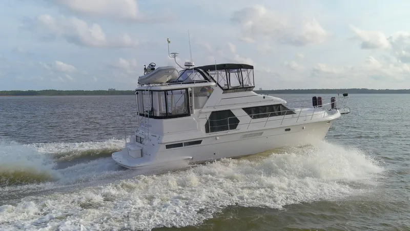Slide: The Image of 1997 Carver 445 Aft Cabin Motor Yacht cruising on open water. - 26