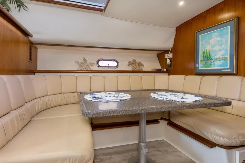 Slide: The Image of 1997 Carver 445 Aft Cabin Motor Yacht interior with cozy dining area and elegant decor. - 5