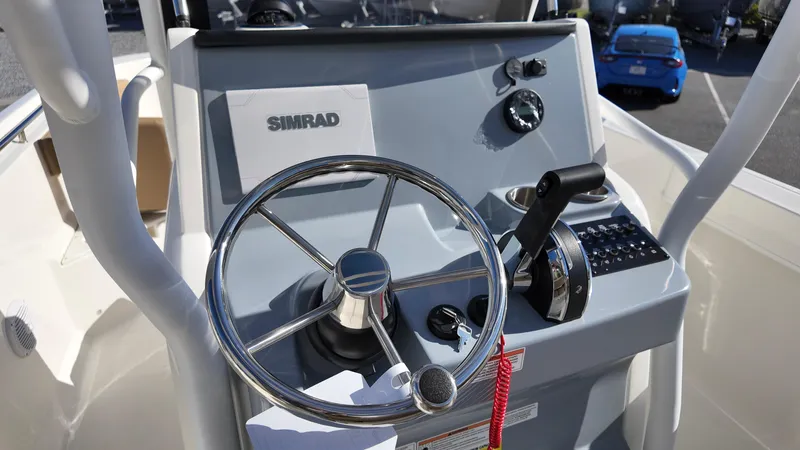 Slide: The Image of 2025 Bayliner Trophy 24 CC helm with steering wheel and controls. - 10