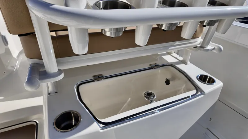 Slide: The Image of 2025 Bayliner Trophy 24 CC boat with rod holders and storage compartment. - 16