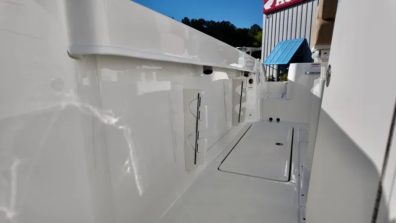 Slide: The Image of 2025 Bayliner Trophy 24 CC boat interior with sleek white finish and storage compartments. - 9