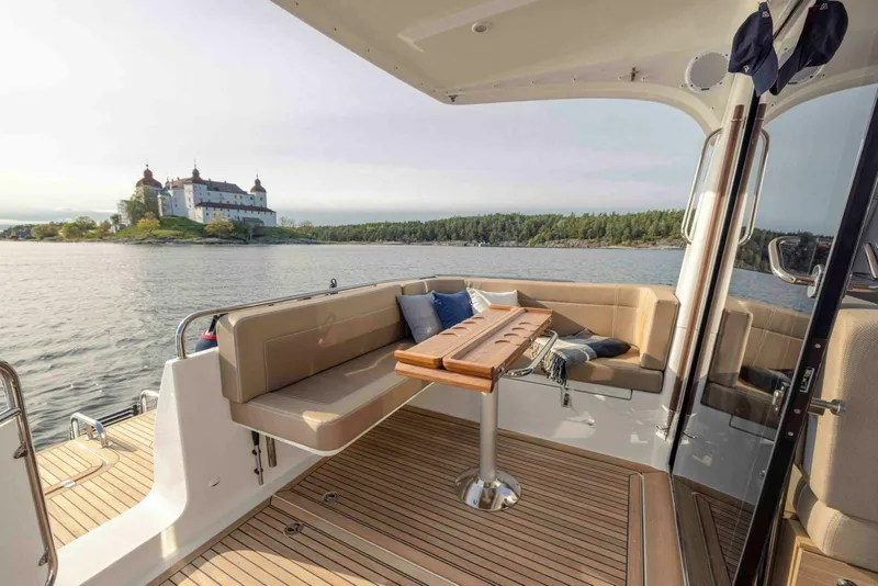 Slide: The Image of Luxurious 2025 Nimbus 365 Coupe yacht with scenic lake and castle view. - 4