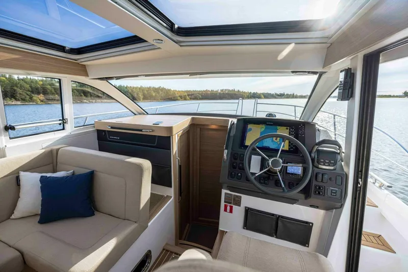 Slide: The Image of Interior of 2025 Nimbus 365 Coupe boat with modern helm and seating area. - 9