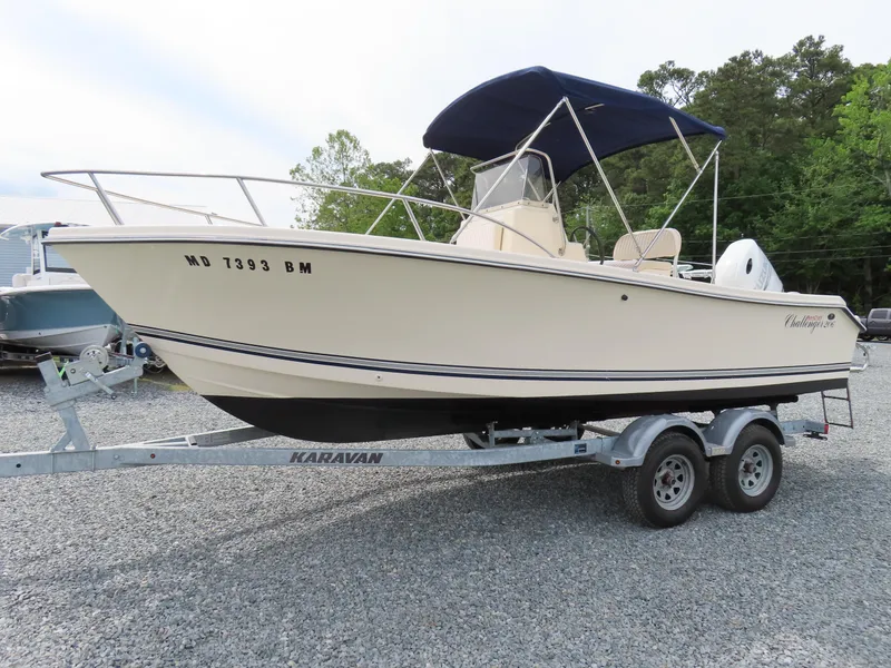 Slide: The Image of 2001 KenCraft Challenger 206 boat on trailer with blue canopy, parked on gravel. - 1