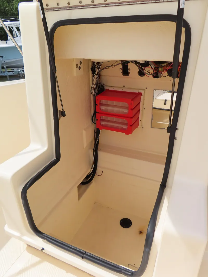 Slide: The Image of 2001 KenCraft Challenger 206 boat storage compartment with wiring and red battery boxes. - 19