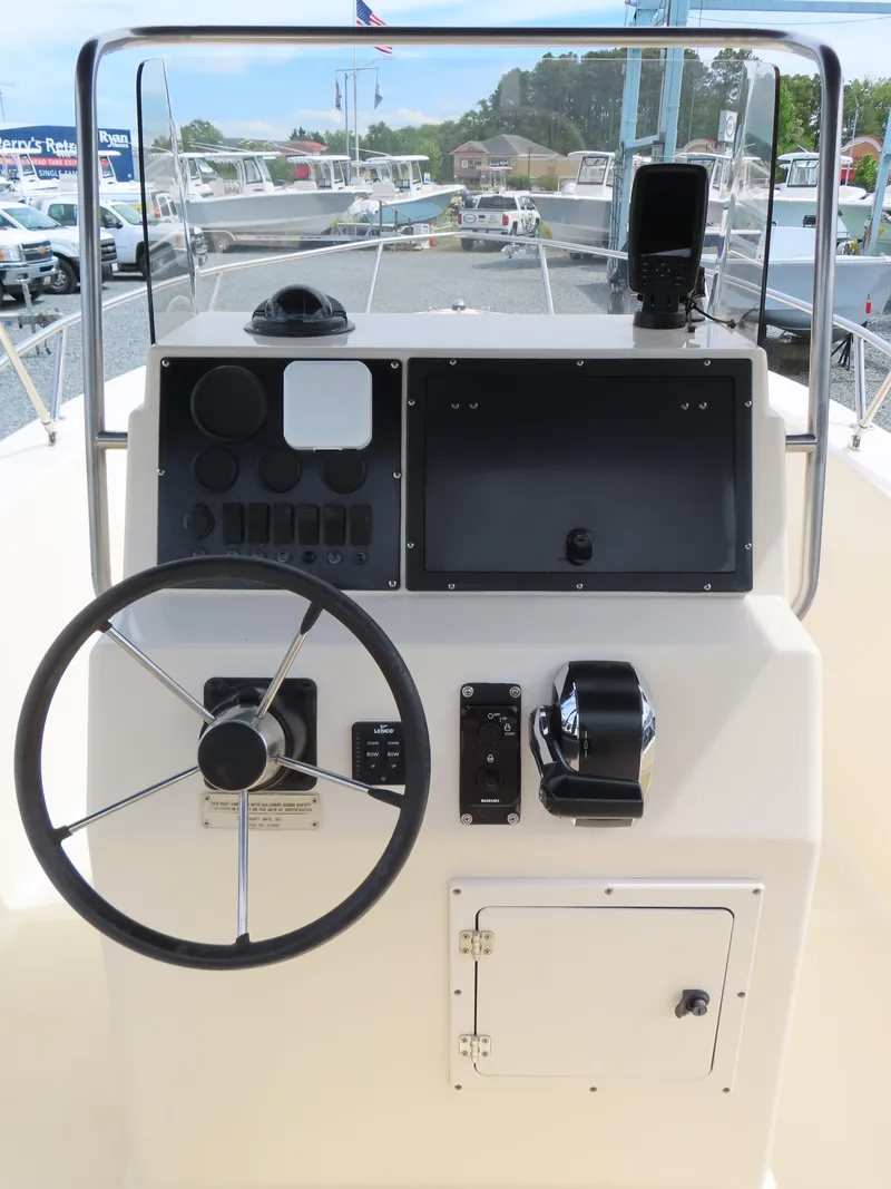 Slide: The Image of 2001 KenCraft Challenger 206 boat console with steering wheel and controls. - 22