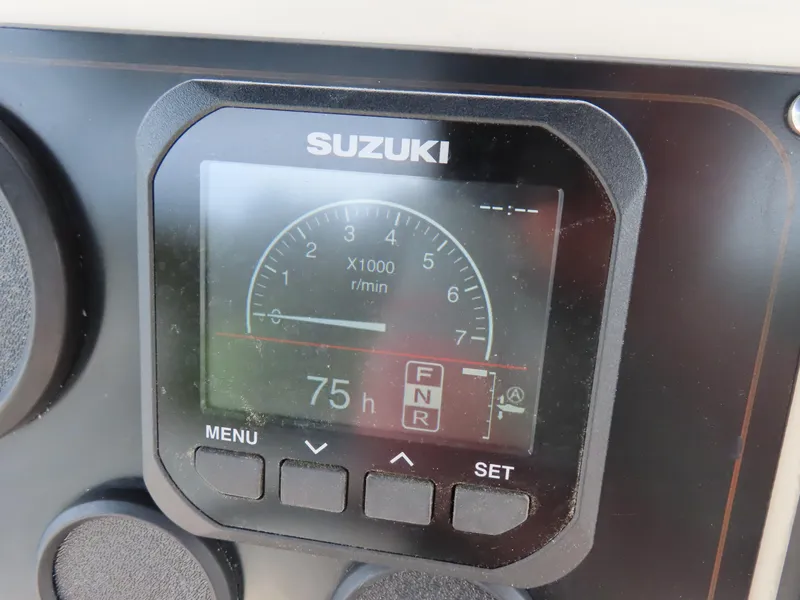 Slide: The Image of Suzuki engine display on 2001 KenCraft Challenger 206, showing 75 hours runtime. - 23