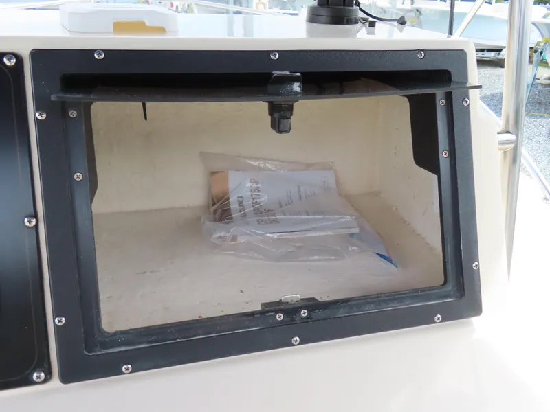 Slide: The Image of Open storage compartment on a 2001 KenCraft Challenger 206 boat. - 25