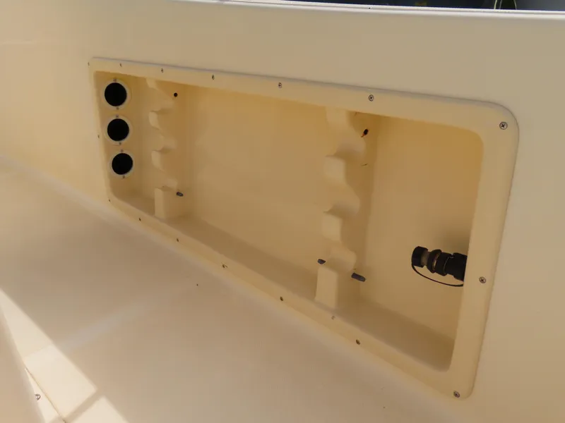 Slide: The Image of Interior compartment of a 2001 KenCraft Challenger 206 boat, featuring storage space and rod holders. - 29